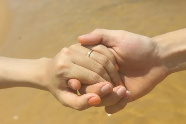 Two people's hands close together, representing trust