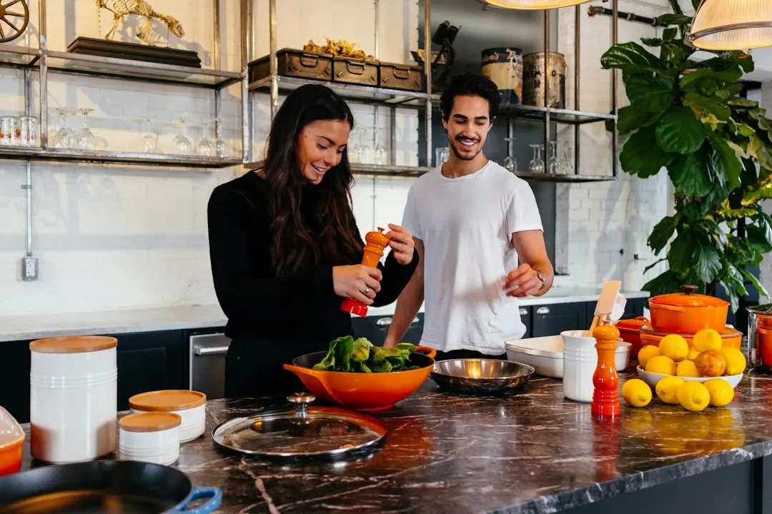 A couple cooking together in a kitchen