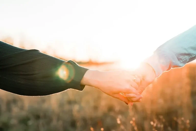 Two people holding hands, representing trust