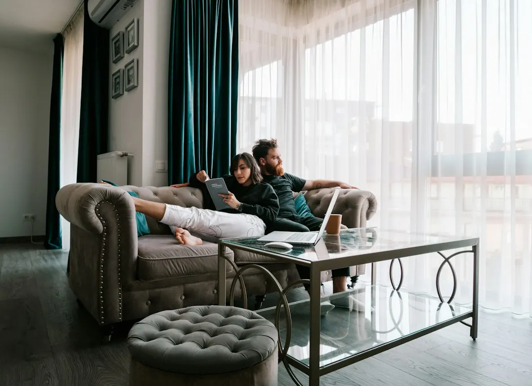 A couple talking through a compromise on a sofa